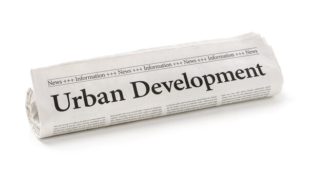 Rolled newspaper with the headline Urban Development