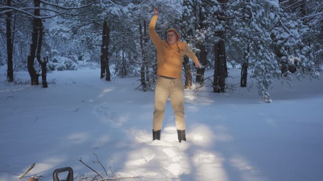 Man doing arm swings warm up during winter workout in snowy forest, Outdoor winter warm up with arm mobility exercises in deep snow