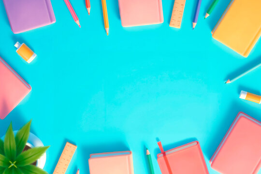 Back to School Concept with Notebooks, Pencils and rules on Blue Background Copy Space