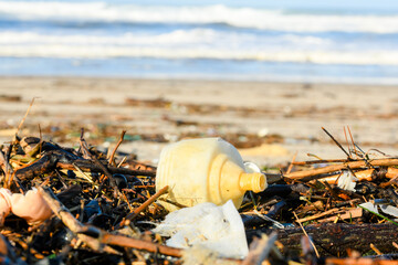 Plastic and wood waste after a storm polluting the beach