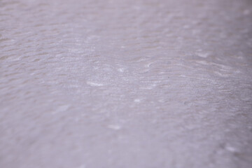 Obraz premium Close-up view of textured white surface with subtle ripples and variations, showcasing a smooth, soft appearance suitable for backgrounds or design elements
