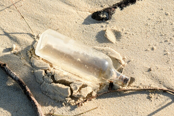 glass bottle polluting the beach