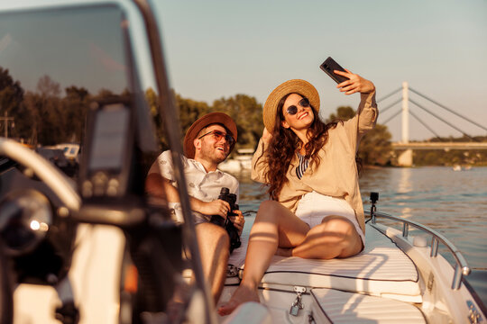 Couple having fun taking selfies while sailing on a boat on Danube river in Novi Sad city, Serbia