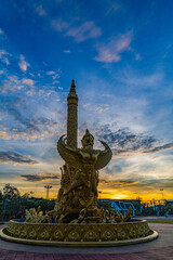 Obraz premium The Golden Garuda Monument at Thung Sri Mueang Public Park. The illuminated monument stands against a dramatic twilight sky and represents Thai mythology, cultural heritage and spirituality