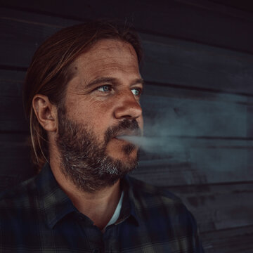 Man with a beard smoking