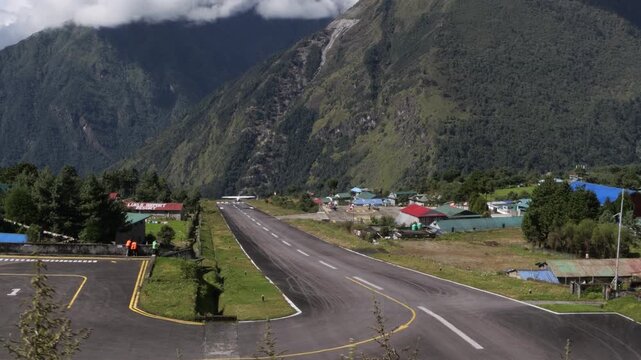 Aircraft leaving Lukla Airport runway in Lukla, Nepal
