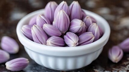 Small, purple flower buds in a white bowl