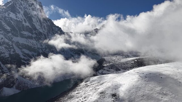 Flight in the clouds over Chola Lake in Everest Region, Himalayas, Nepal