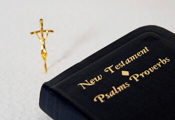 New Testament book and a small golden crucifix
