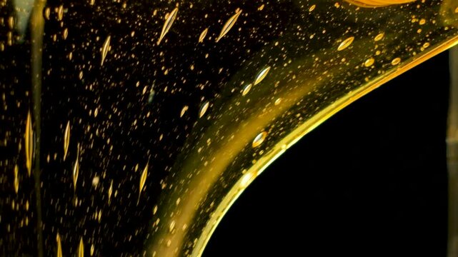 Creative Background Macro Honey Flow on Black Background Slow Motion.