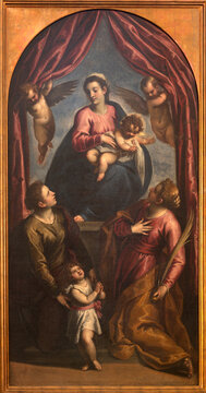 MORTARA, ITALY - JANUARY 18, 2026: The painting of Madonna with thewith early Christian martyrs in the church  Abbazia di Santa Croceby Palma il Giovanne from 16. cent. 