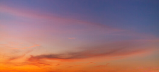 Fototapeta premium Dramatic Twilight Sky with Vibrant Orange and Purple Sunset Clouds,A breathtaking panoramic view of a dramatic sunset sky, featuring a vibrant gradient of fiery orange, deep red, and moody purple.