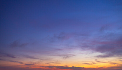 Fototapeta premium Dramatic Twilight Sky with Vibrant Orange and Purple Sunset Clouds,A breathtaking panoramic view of a dramatic sunset sky, featuring a vibrant gradient of fiery orange, deep red, and moody purple.