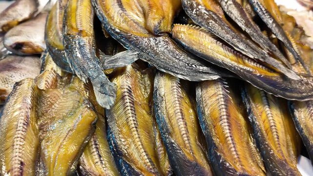 Close-Up of Dried Smoked Fish Displayed at Asian Market Stall