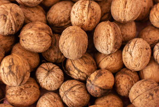 Walnuts close up background, top view natural food texture