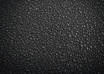 Fototapeta premium close-up of dark wet asphalt pavement texture evoking a gritty urban mood