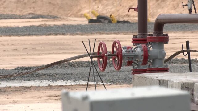 Old structure of the oil wellhead with pipe fittings, valves and measuring equipment. Equipment for wellhead connection oil well and shut-off control valves for pumping crude oil in oilfield

