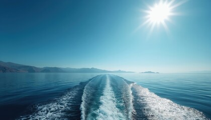 Boat wake on calm ocean water under bright sun and clear blue sky. Mountains visible on distant island shore. Peaceful travel and scenic seascape.