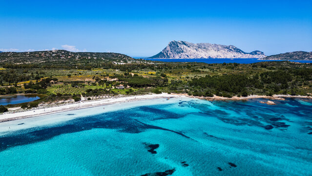 Aerial view of Lu Impostu beach with Tavolara Island, San Teodoro, Sardinia, Italy.