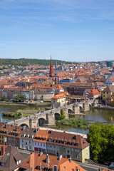 Obraz premium Panoramic view from Festung Marienberg overlooking Würzburg’s historic old town, the Main River and the iconic Old Main Bridge lined with monumental statues.