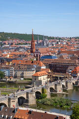 Obraz premium Panoramic view from Festung Marienberg overlooking Würzburg’s historic old town, the Main River and the iconic Old Main Bridge lined with monumental statues.
