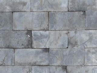 Fototapeta premium Square blocks of gray volcanic rock arranged in a specific pattern.