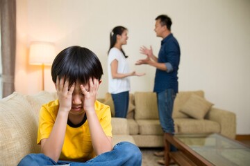 Distressed Boy Hiding on Couch While Parents Argue in Background