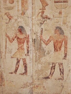 Painted wall reliefs of a standing noble with staff and scepter in the Mastaba of Ptahhotep II, Saqqara, Egypt
