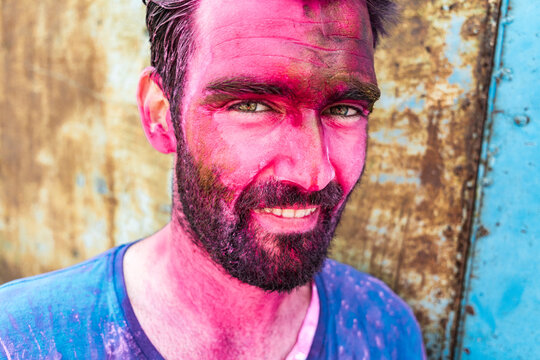 Independent traveler with colorful Holi face paint