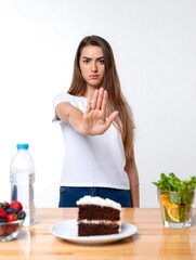 Young Woman Refusing Cake - Healthy Eating, Diet, and Wellness Concept