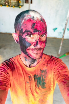 Surprised expression during vibrant Holi ritual