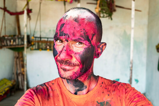 Bold traveler confronting camera in Holi ritual