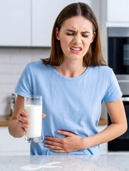 Woman Holding Glass of Milk Experiencing Stomach Pain