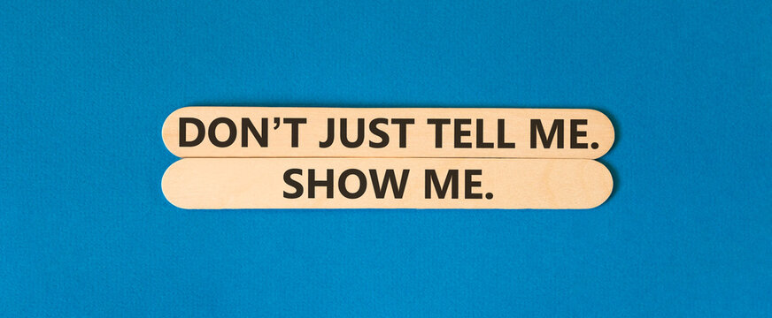 Tell or show symbol. Concept words Do not just tell me, show me beautiful wooden sticks. Beautiful blue background. Business tell or show concept. Copy space.