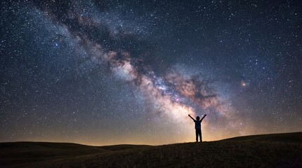 Obraz premium Boy stands in tall grass looking at night stars concept. A person admires the breathtaking Milky Way in the night sky.