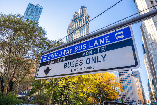 Broadway bus lane sign with buses only restriction above Manhattan street in New York City