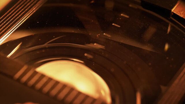 Rewinding the Video Tape Inside of the Dusty Plastic Cassette Shell - Macro, Warm 90s Mood