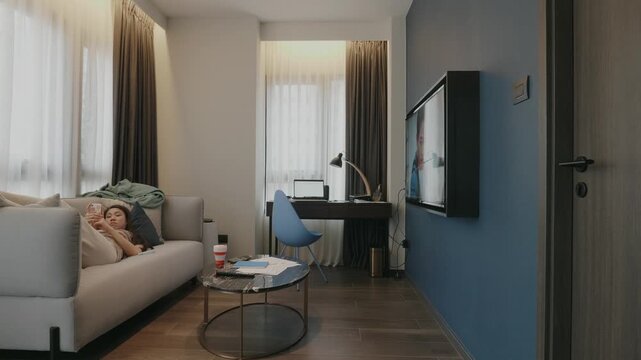 A cozy living area featuring a comfortable couch, a stylish coffee table, and ample natural light. This modern design blends functionality and aesthetic appeal, perfect for relaxing or working.