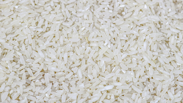 Close-up of uncooked white rice grains, detailed texture, top view