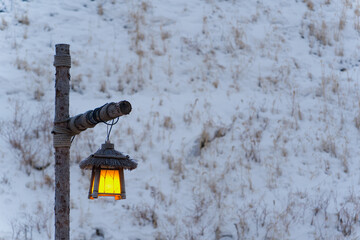 Warm Lantern and Large Moon Installation in a Wintry Garden at Night © Denise