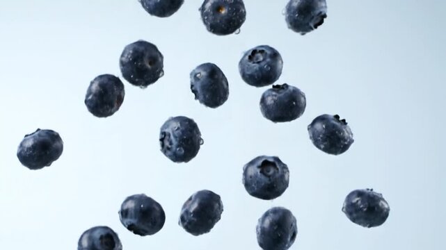 Fresh blue berries captured in a captivating dynamic display, showcasing their natural plumpness and refreshing moisture as they float in a bright, clean space