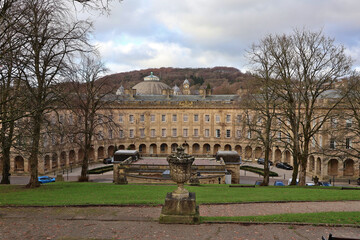Obraz premium Historic Buxton Crescent; iconic Georgian architecture and luxury thermal spa building in Buxton, Derbyshire with The Slopes garden in foreground, Peak District, England