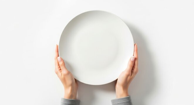 Hands holding a clean, empty white ceramic plate isolated on a white background mokap images