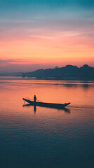 Fototapeta premium Solitary fisherman boat river sunrise calm reflection orange blue sky silhouette