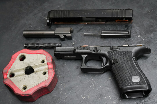 Baltic States, February 21, 2026. Field stripped Glock 19 Gen6 semi-automatic pistol with slide, barrel and frame separated.