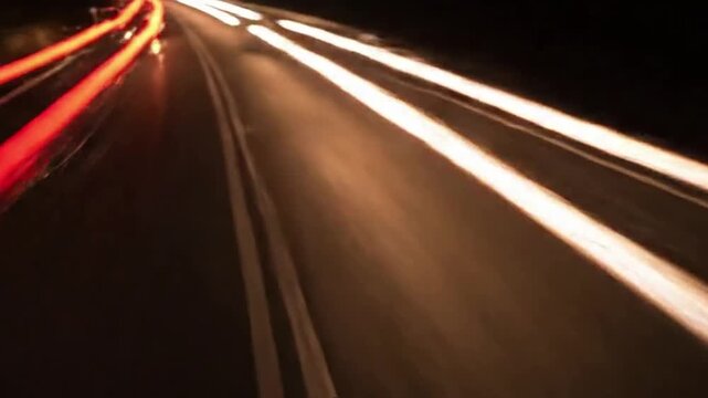Futuristic Energy Flow on Night Road Elevated view from a bridge or cliff, showcasing the continuous flow of light trails resembling data streams or energetic conduits through a dark, rural landscape.