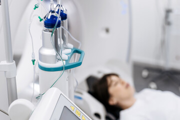 Patient undergoing radiology scan with MRI or CT equipment in clinical setting. Healthcare diagnostics concept
