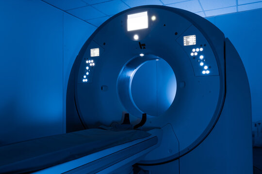 Hospital radiology room with high tech CT scanner. Medical examination and imaging concept
