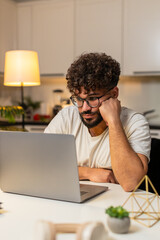 Arabian man at home ends remote laptop job feels bored tired stress burnout wants rest. Egyptian...
