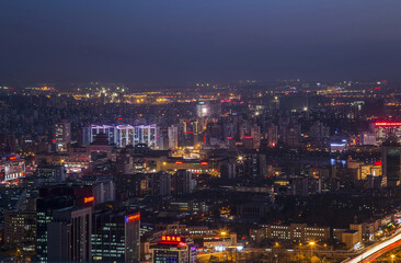 Naklejka premium The Capital City Night Skyline with Illuminated Buildings and Neon Lights